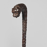 AN INTRICATELY CARVED WALKING STICK -    - Travel and Leisure Auction