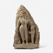 A SANDSTONE SCULPTURE OF A DEVI WITH DEVOTEE ON RIGHT AND CHILD ON LEFT - Live Auction: South Asian Treasures