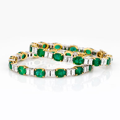 A PAIR OF EMERALD AND DIAMOND BANGLES